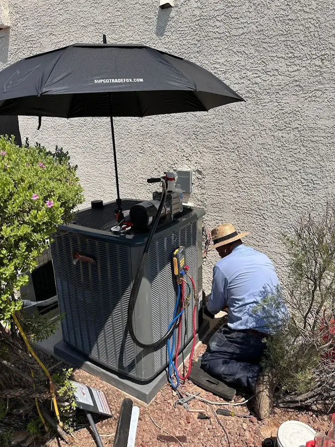 HVAC technician performing outdoor AC maintenance in Moon